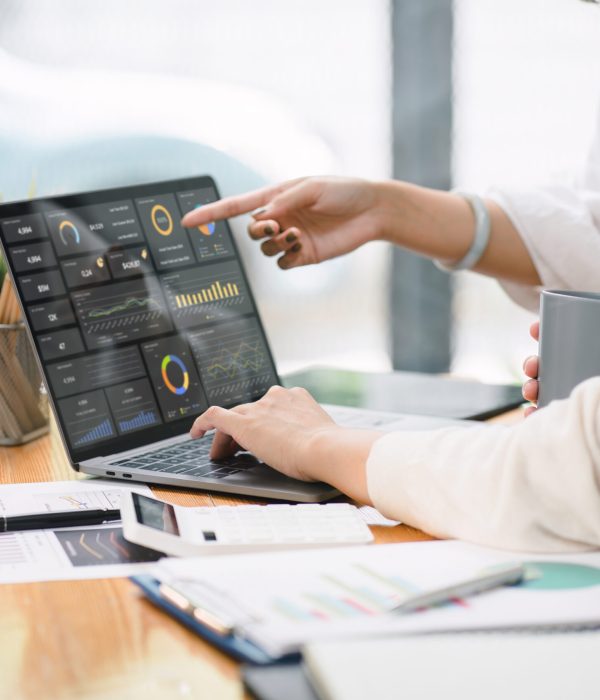 Advisor financial business analytics woman team analyzing data charts, graphs, and a dashboard on laptop screen. Data analysis concept.